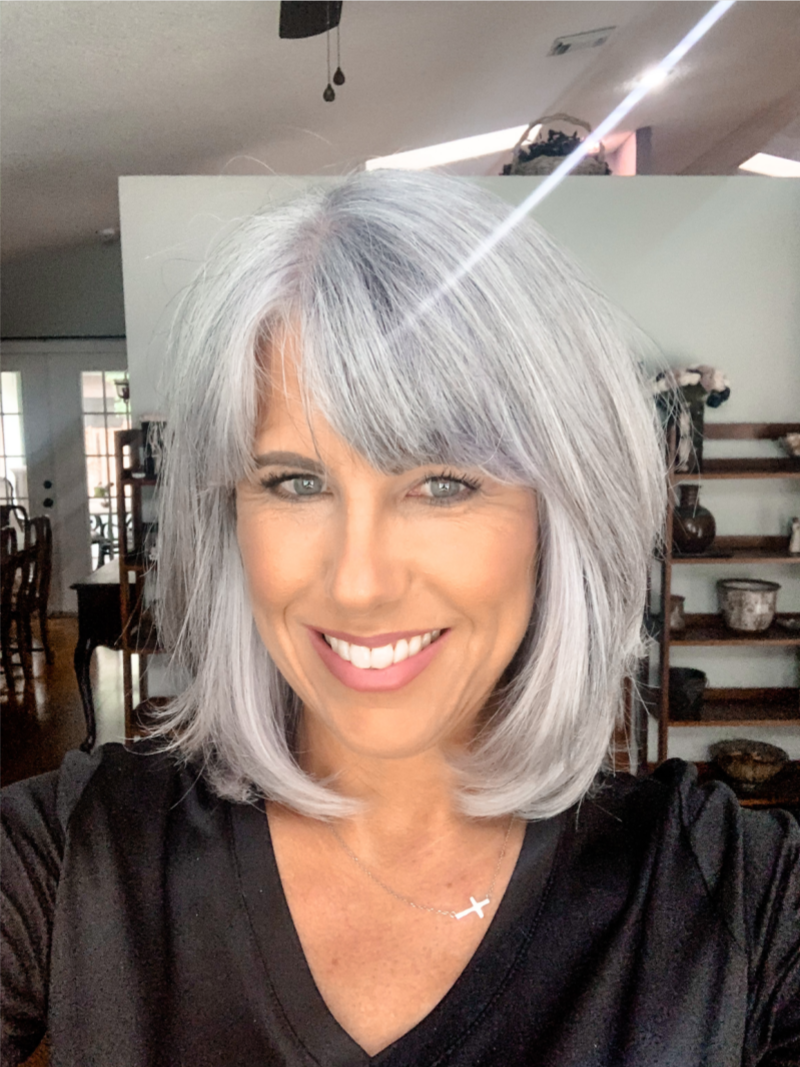 Woman confidently wearing a silver-gray bob hairstyle.